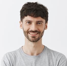 smiling man in a gray pullover